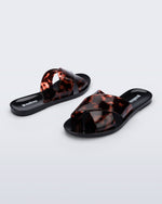 Back and angled view of a pair of black Essential Cross Slide sandals with tortoise colored straps