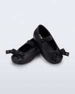 Angled view of a pair of black Sophie Crush baby ballerina flats with bow