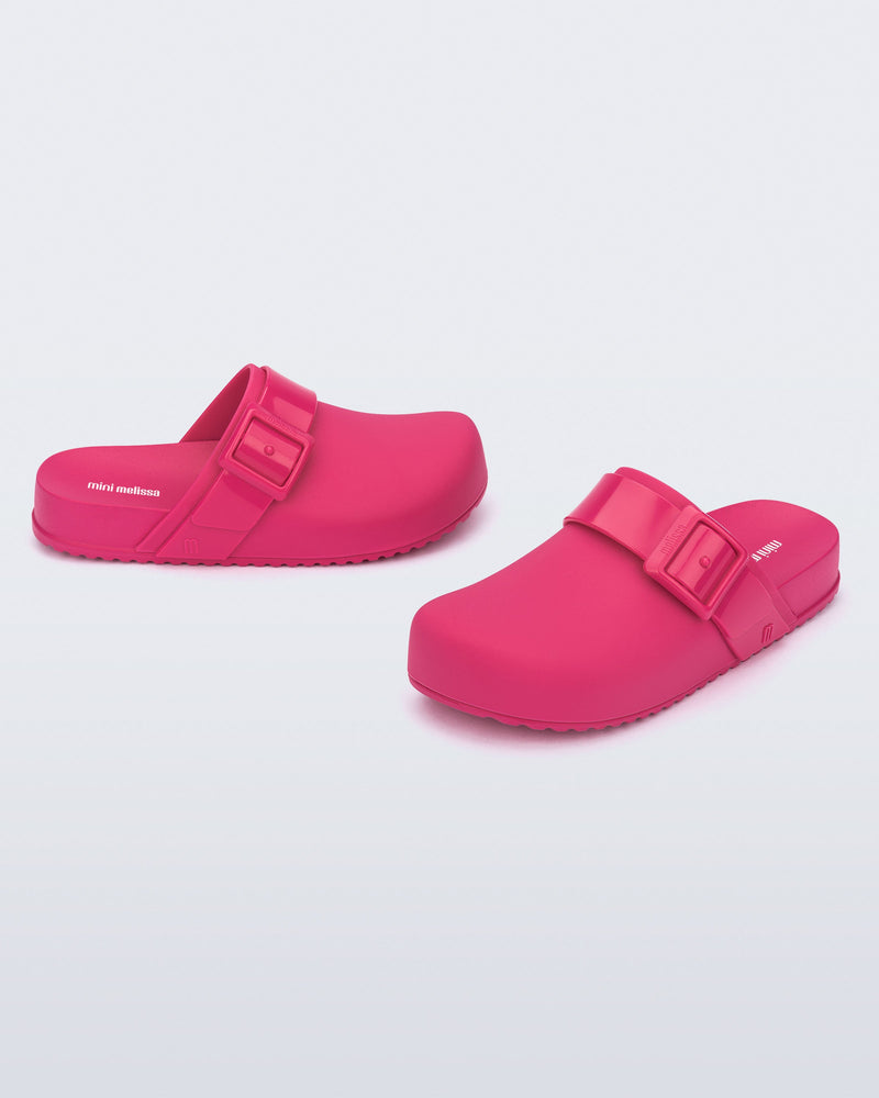 Angled view of a pair of pink kids Cozy Clogs