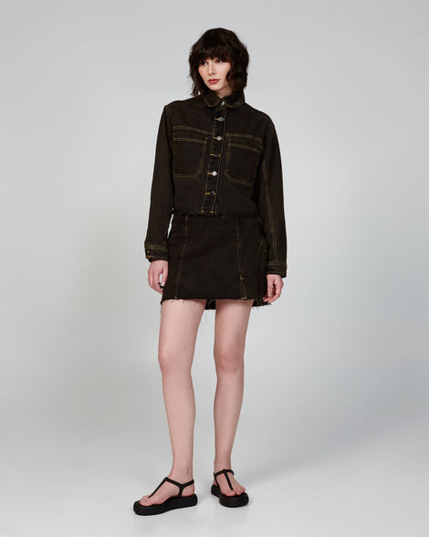 Model in a black jean skirt outfit wearing a pair of black Sun Leme Platform sandals