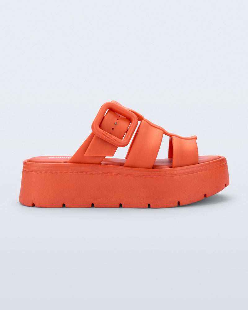 Side view of an orange Pump Platform sandal