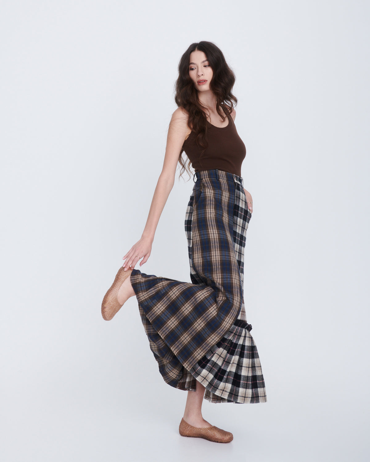 Model in a plaid brown long skirt and brown tank wearing a pair of clear beige Campana Papel Hug flats