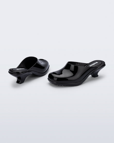Back and angled view of a pair of black Gaia kitten heels with peep toe