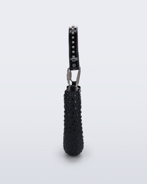 side view of a black Nina Bag + Alexandre Pavao shoulder bag with grey accents