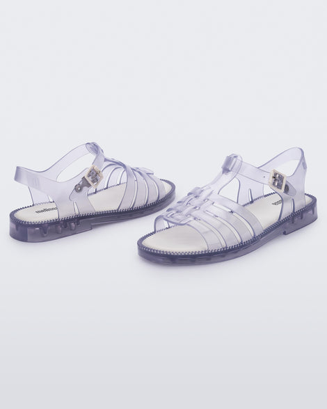 Angled view of a pair of clear Possession Fresh fisherman style sandals with open toe.