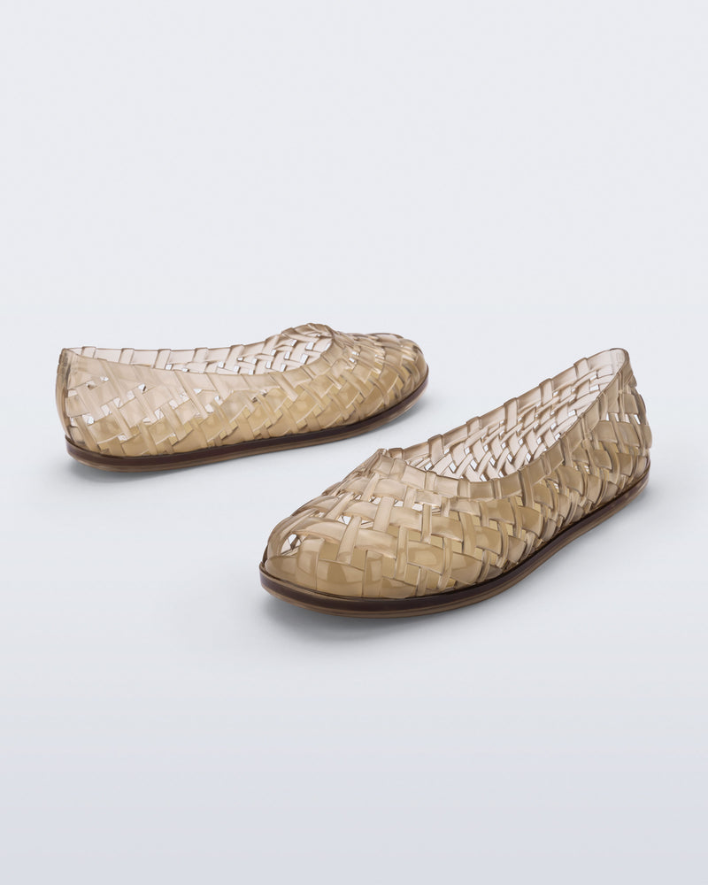 Side and angled view of a pair of beige Possession Ballerina flats