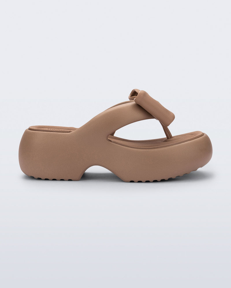 Side view of a brown Free Fuzzy Platform flip flop