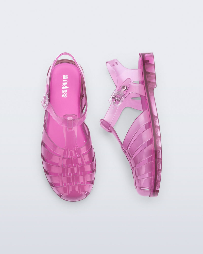 Top and side view of a pair of transparent pink Possession fisherman sandals