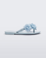Side view of a blue Harmonic Springtime kids flip flop with three blue flowers.