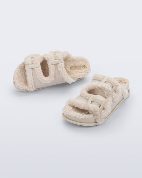 Top and angled view of a pair of beige Cozy Warm Slides with beige fuzzy insoles