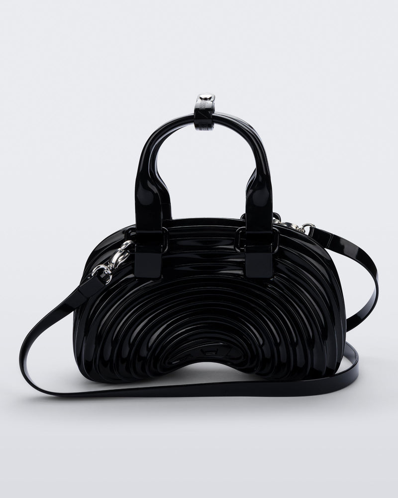 Front view of a black Quantum Dome + Diesel bag with hand strap and shoulder strap
