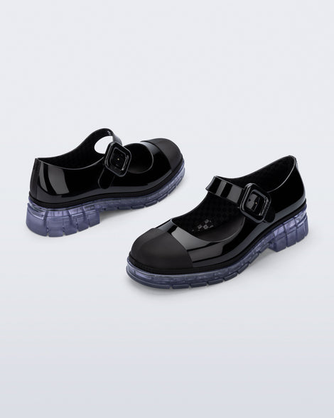 Back and side angle view of a pair of black with clear sole June mary janes with matte toe cap