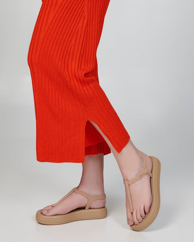 Model's legs wearing a pair of beige Sun Leme Platform sandals
