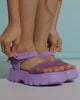 Video with no sound of a model's legs wearing a pair of purple Kick Off kids Sandals.