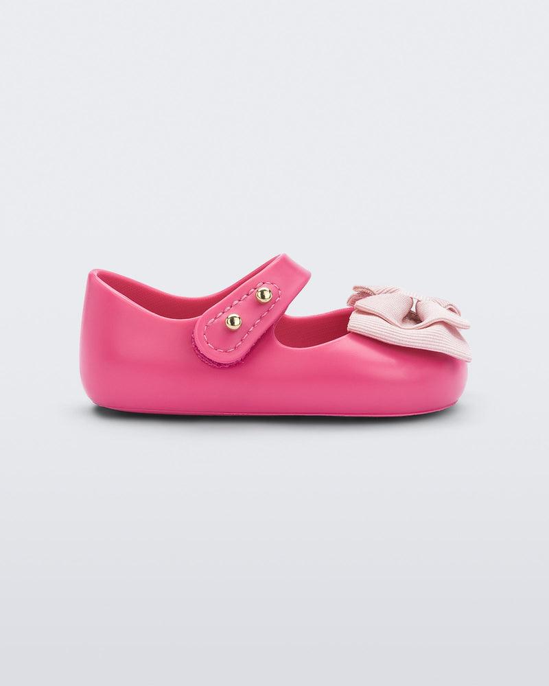 Side view of pink My First Melissa mary jane with a pink bow.