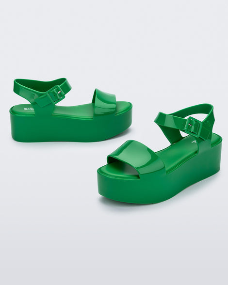 An angled front and side view of a pair of green Melissa Mar Platform sandals with two straps.