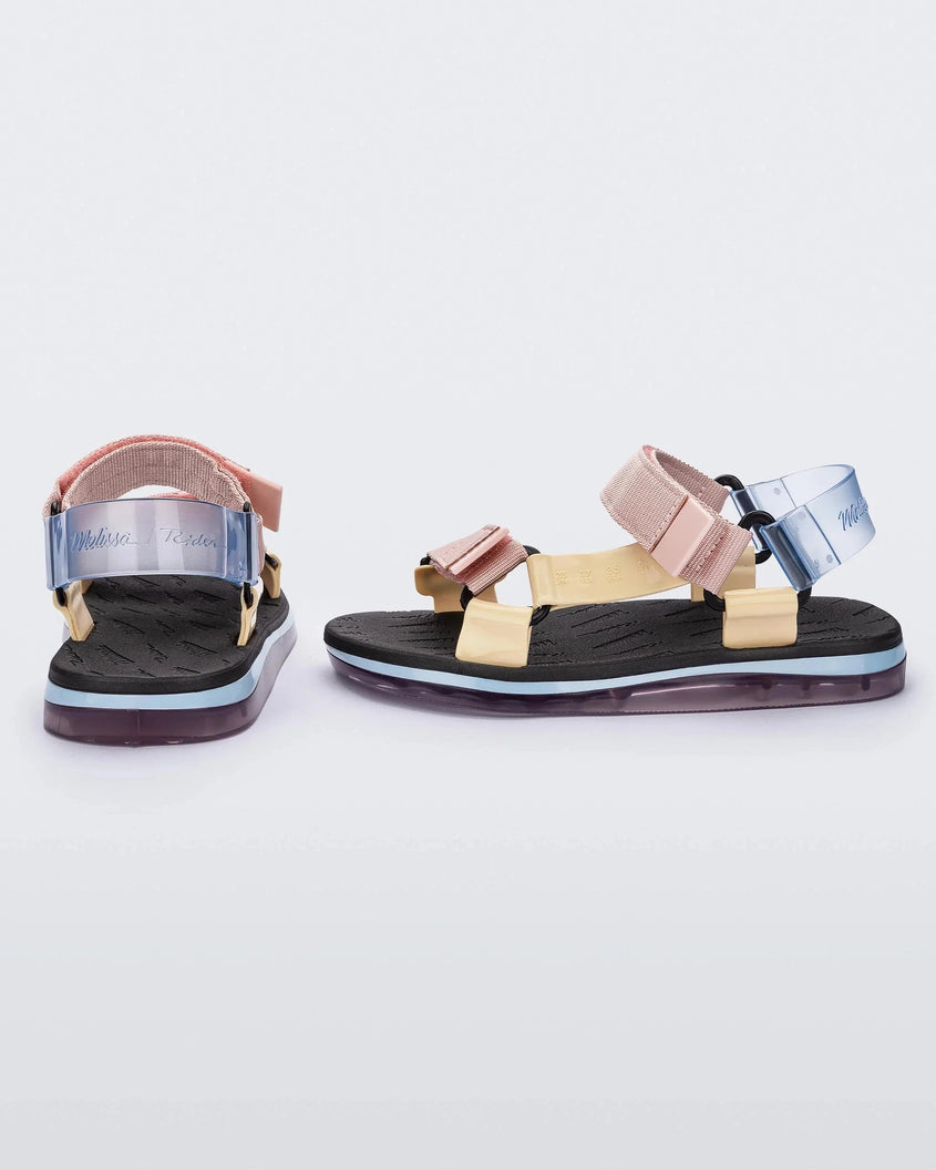 Side and back view of a pair of black Melissa Papete sandals with pink, yellow, and clear straps.