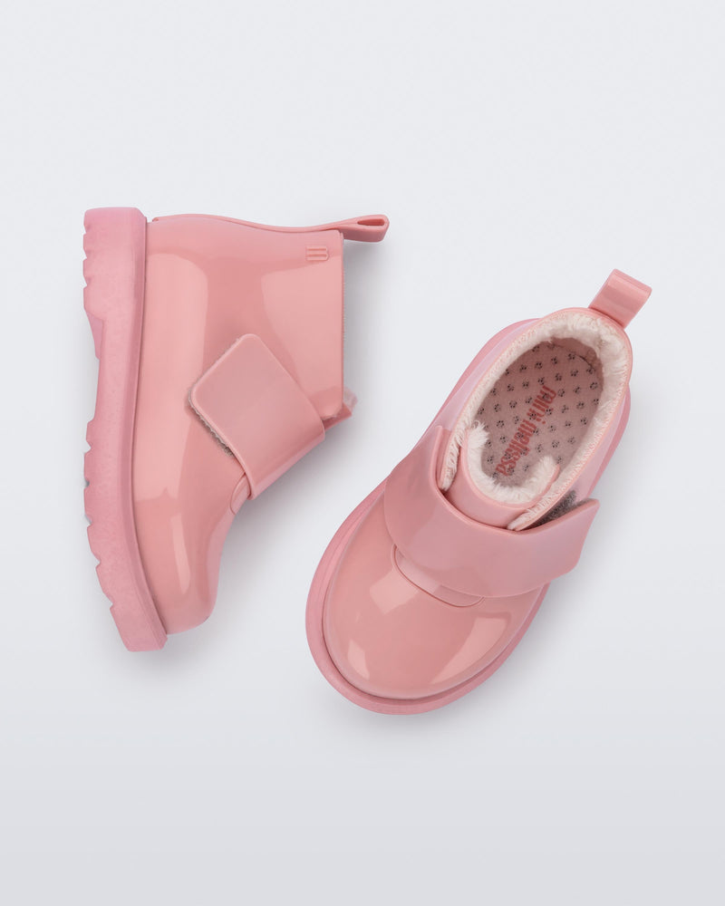 Top and side view of a pair of pink baby Chelsea boots with faux fur lining