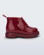 Side view of a red baby Chelsea boot