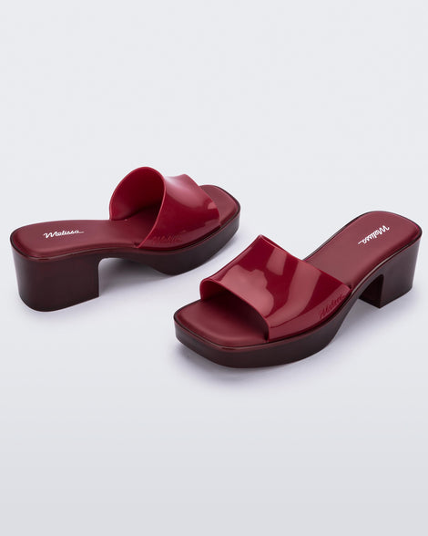 front and back view of a pair of Melissa Shape heeled slides in Red