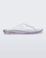 Side view of a clear Melissa Real Jelly Flip Flop.