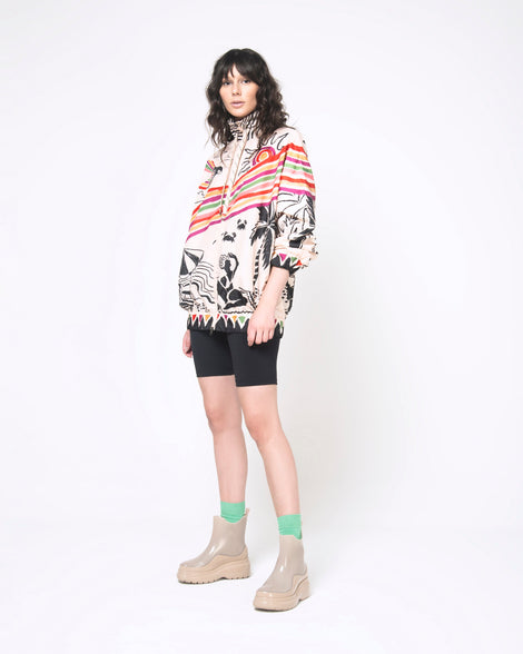 A model posing for a picture wearing a pair of brown Melissa Grip short rain boots.