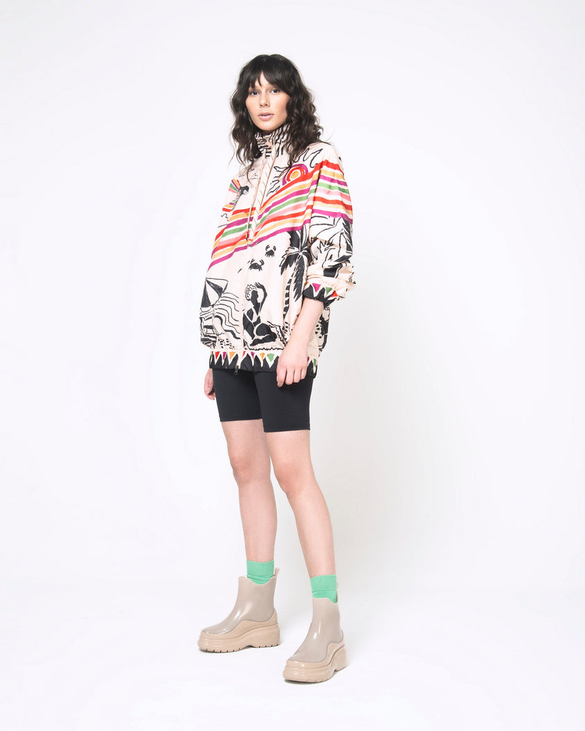 A model posing for a picture wearing a pair of brown Melissa Grip short rain boots.