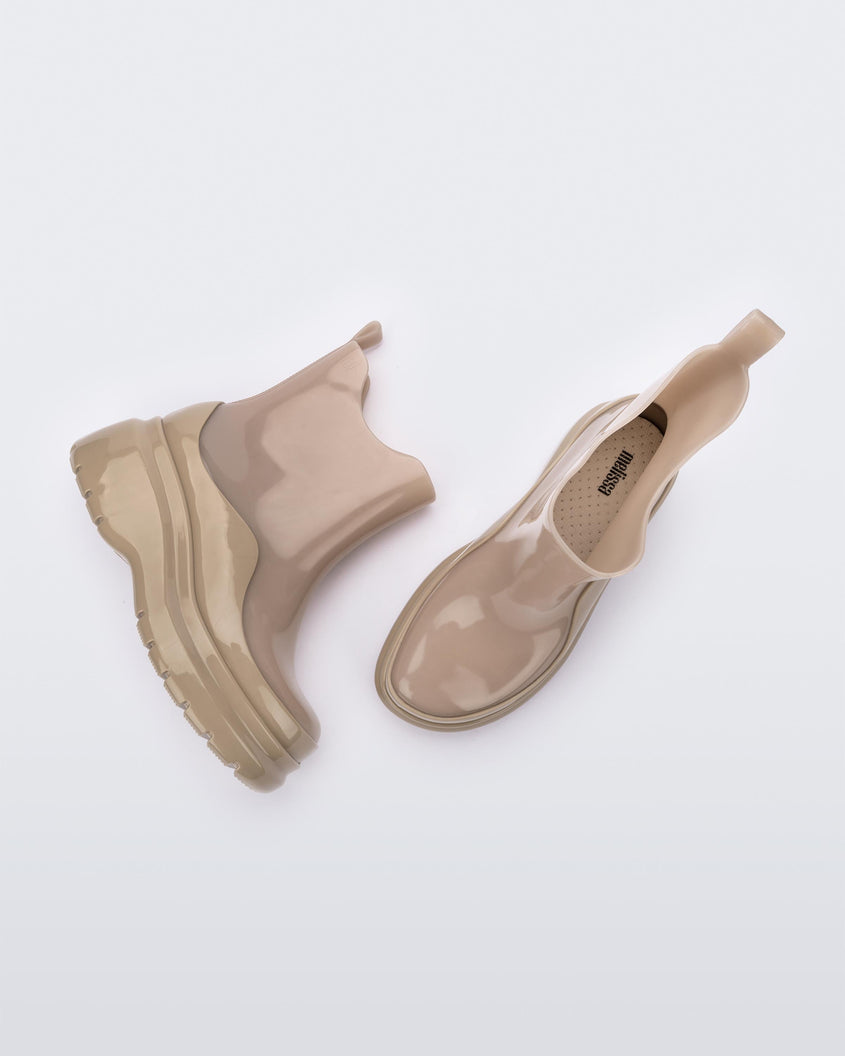 A side and top view of a pair of brown Melissa Grip short rain boots.