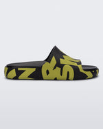 Side view of a black and white cow print Melissa Cloud slide with a black insole reading in blue