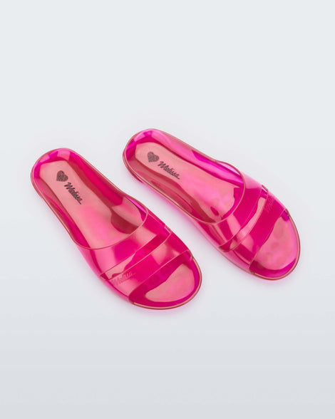 Top view of a pair of clear pink Melissa Real Jelly Slides with two front straps.