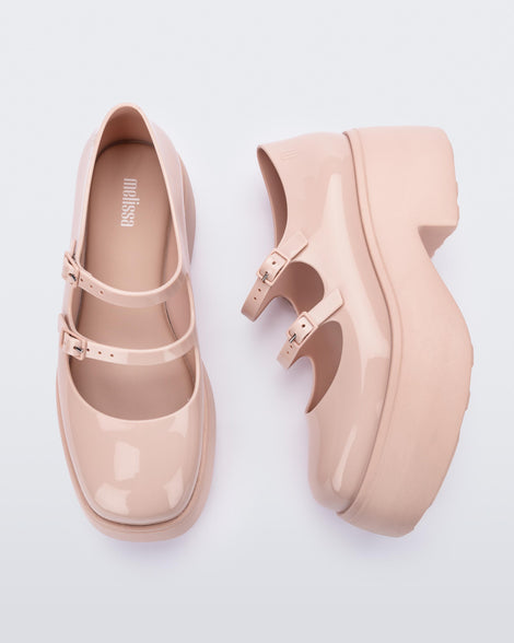 A top and side view of a pair of pink Melissa Farah platform shoes with two straps fastened by pink buckles.