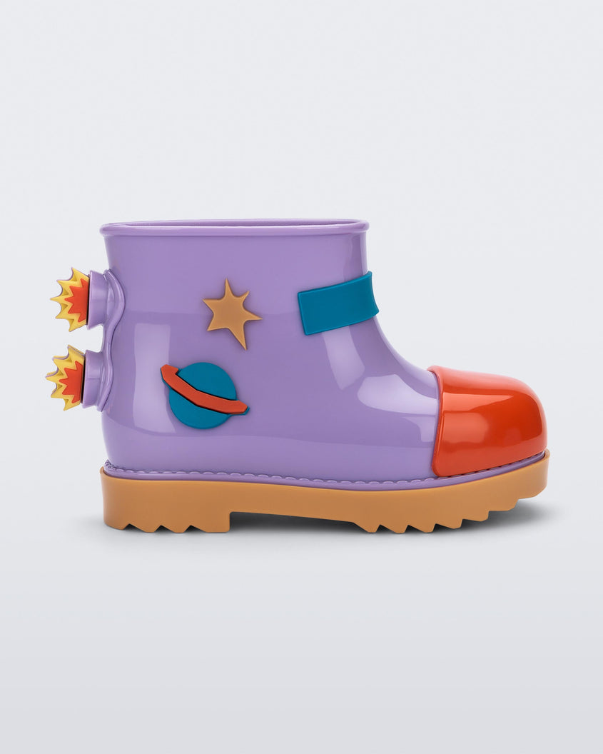 Side view of a carmel/lilac/red Mini Melissa Rain Boot with a lilac base, red toe, brown sole, and a planet, star and fire detail on the side and back.
