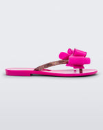 Side view of a dark pink Melissa Harmonic Sweet flip flop with a pink bow and multicolor glitter straps.