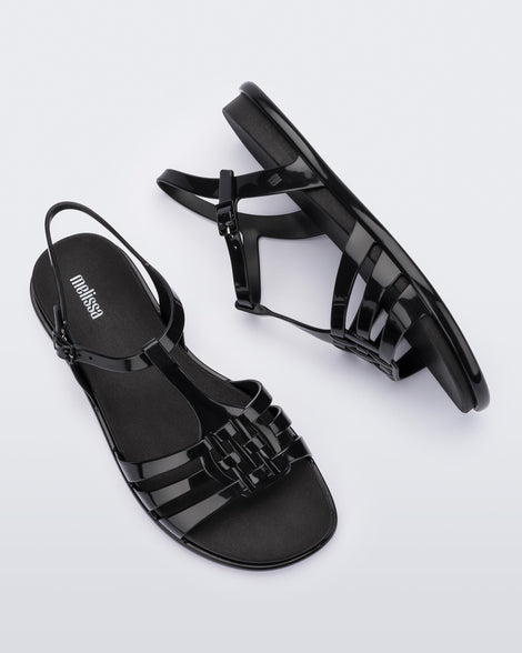 Top and side view of a pair of Melissa Party sandals in black with back ankle strap and buckle closure