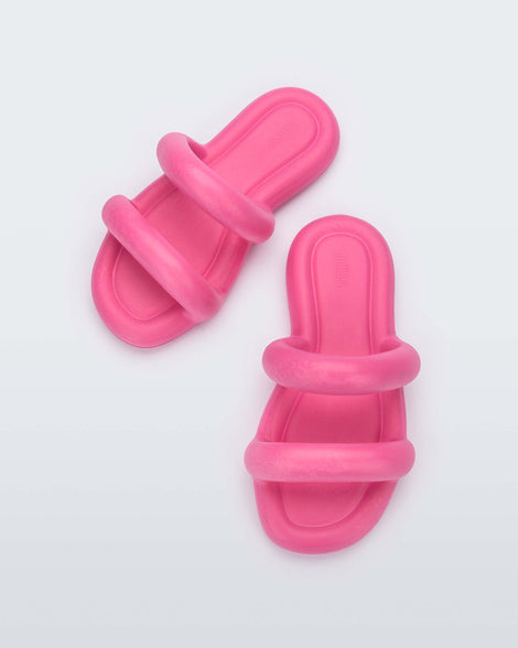A top view of a pair of pink Melissa Free Bloom Slides with puffer-like straps.
