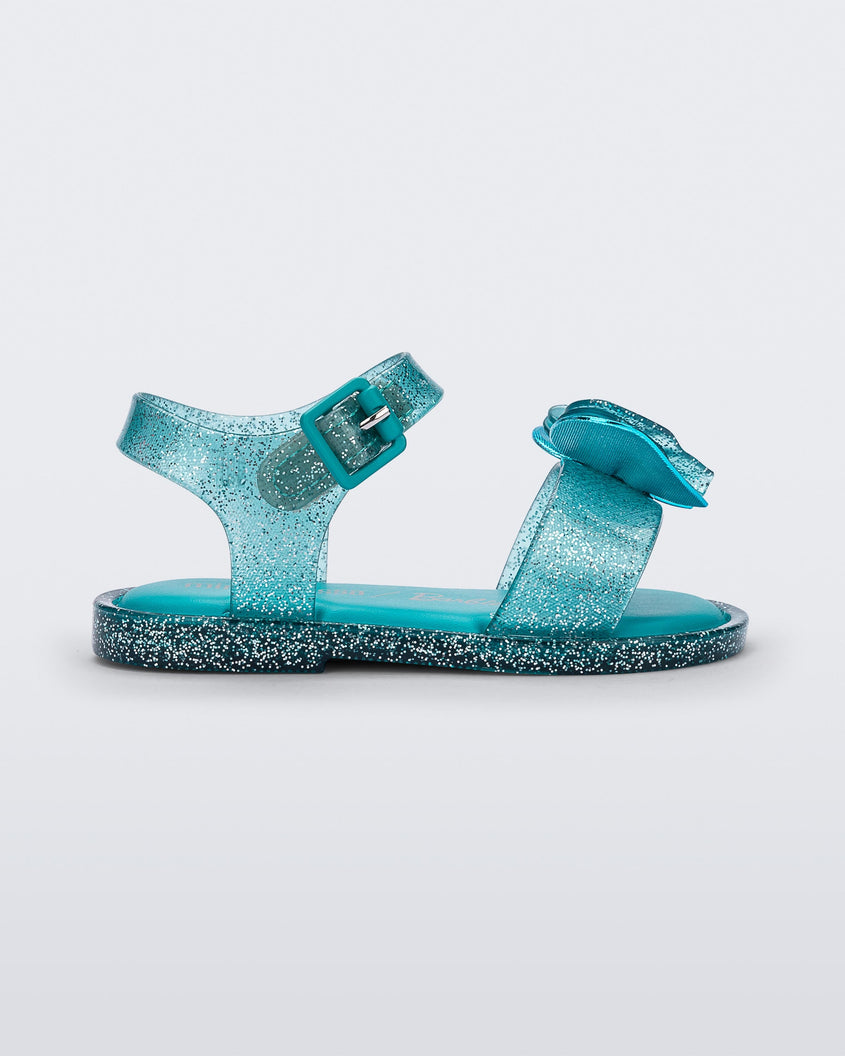 Side view of a blue glitter Mini Melissa Mar Sandal with a bow.