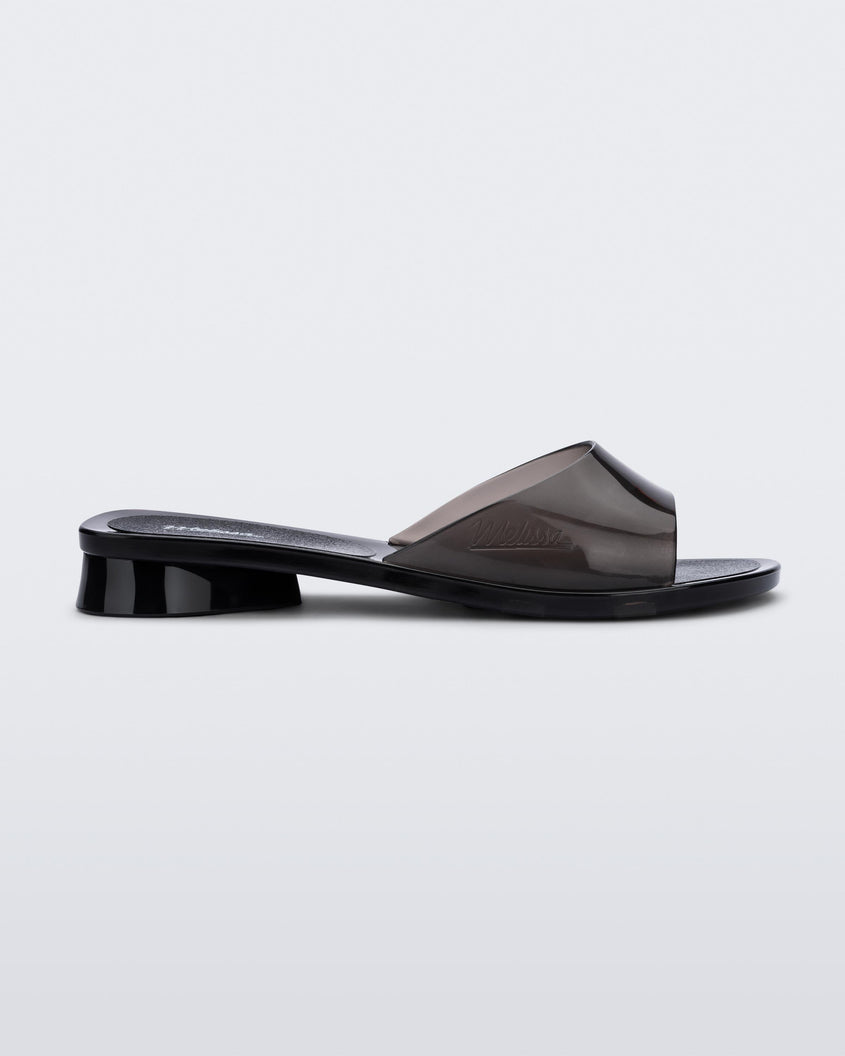Side view of a transparent black Melissa Kim slide.