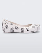 Side view of a white/grey Mini Melissa Ultragirl Cats & Dogs flat with a white base and cartoon dog face drawing pattern across the base.