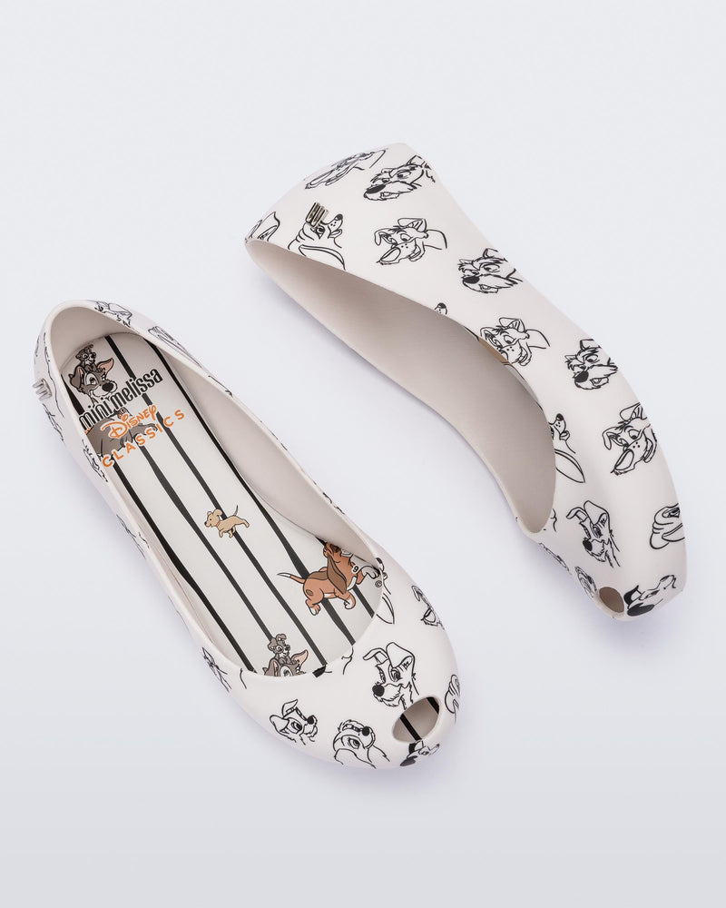 A top and side view of a pair of white/grey Mini Melissa Ultragirl Cats & Dogs flats with a white base and cartoon dog face drawing pattern across the base.