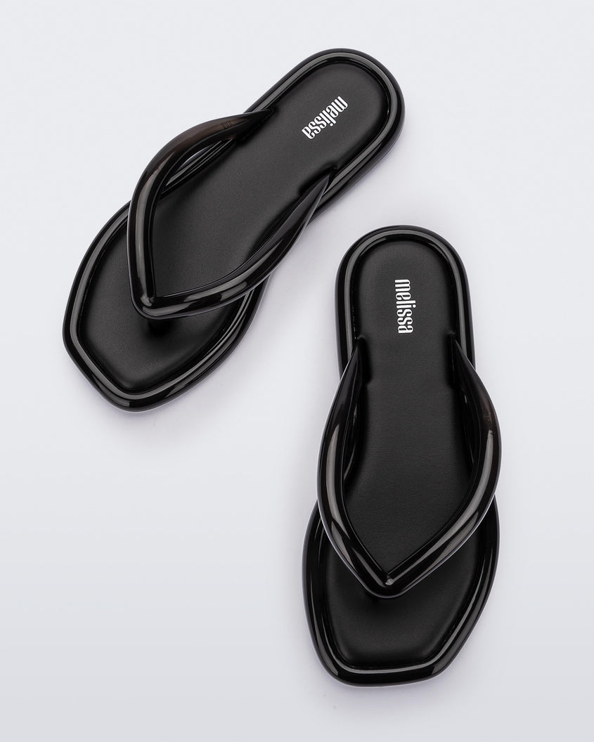Top view of a pair of black Melissa Airbubble Flip Flops.