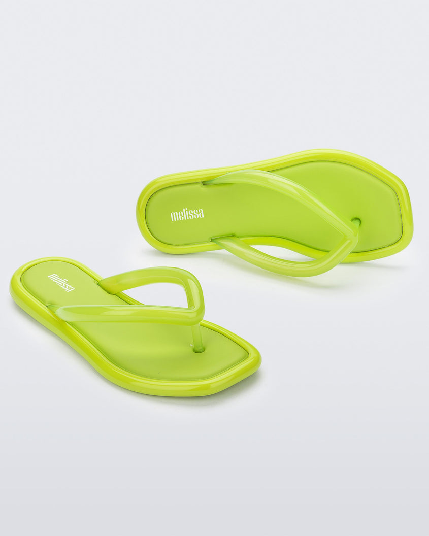 Angled view of a pair of green Melissa Airbubble Flip Flops.