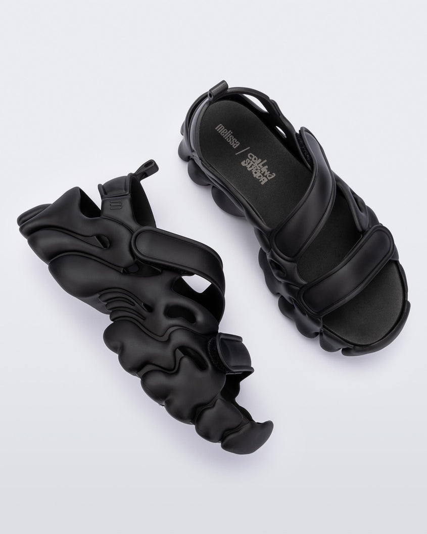 Top and side view of a pair of Melissa Puff chunky sandals in black with velcro straps