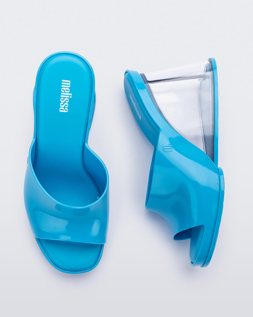 A top and side view of a pair of blue Melissa Darling heels with clear soles.