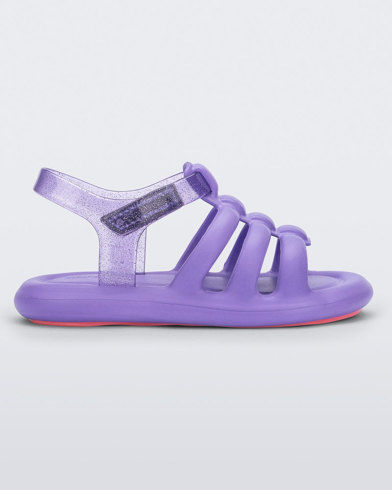 Side view of a lilac Mini Melissa Freesherman with lilac and clear glitter straps.