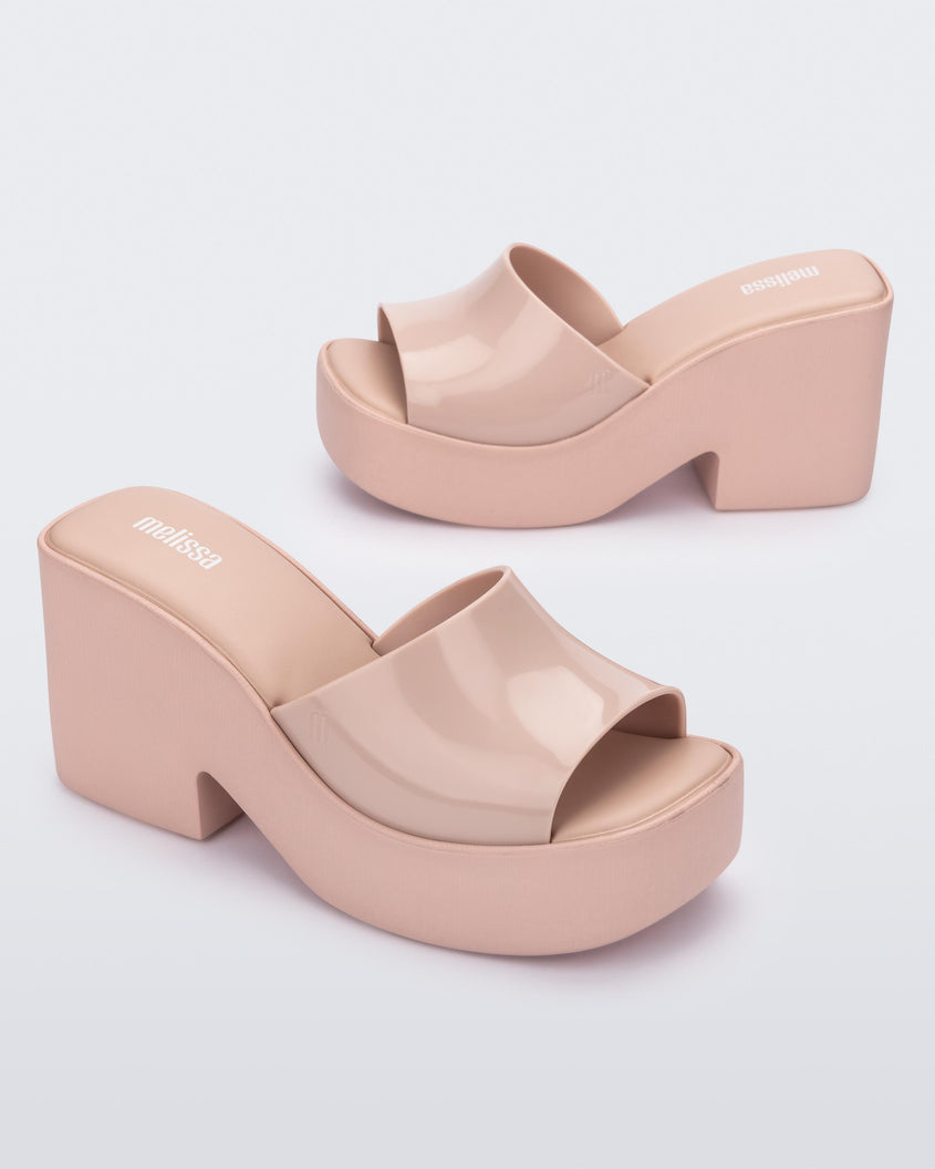 Angled shot of a pair of Melissa Posh platform slide in Pink