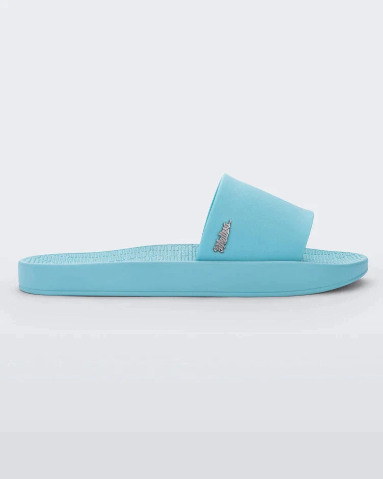 Side view of a light blue Melissa Sun Sunset slide with a