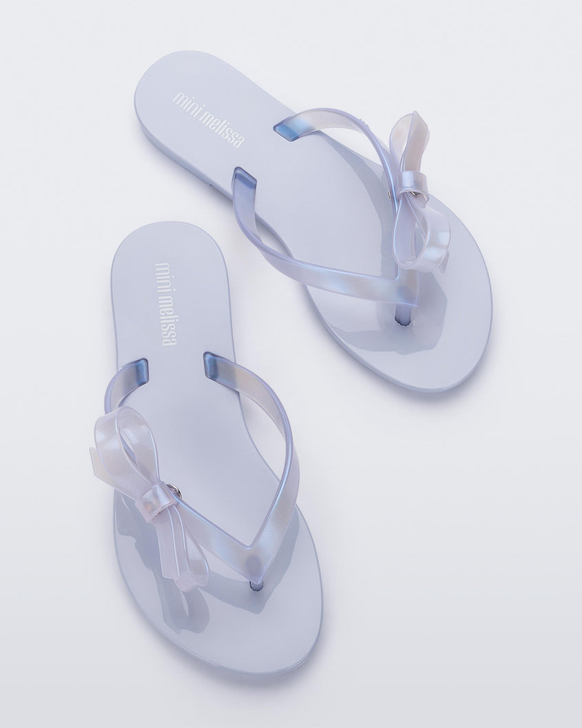 Top view of a pair of Lilac/Blue Pearl Mini Melissa Harmonic Sweet flip flops.