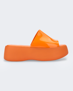 Side view of an orange Melissa Becky platform slide.