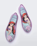 Top view of a pair of purple Mini Melissa Sweet Love Princess flats, with a purple base, Ariel in script on the side, a sea shell detail on the toe, and a drawing of Ariel of The Little Mermaid on the sole.