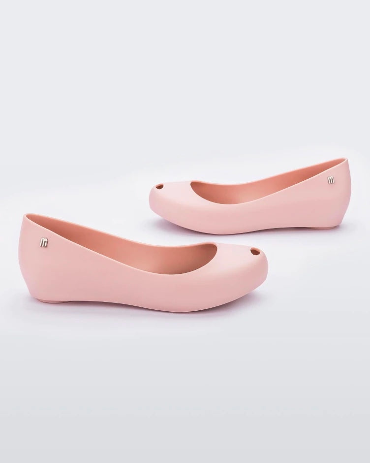 Side view of a pair of light pink Melissa Ultragirl Basic flats